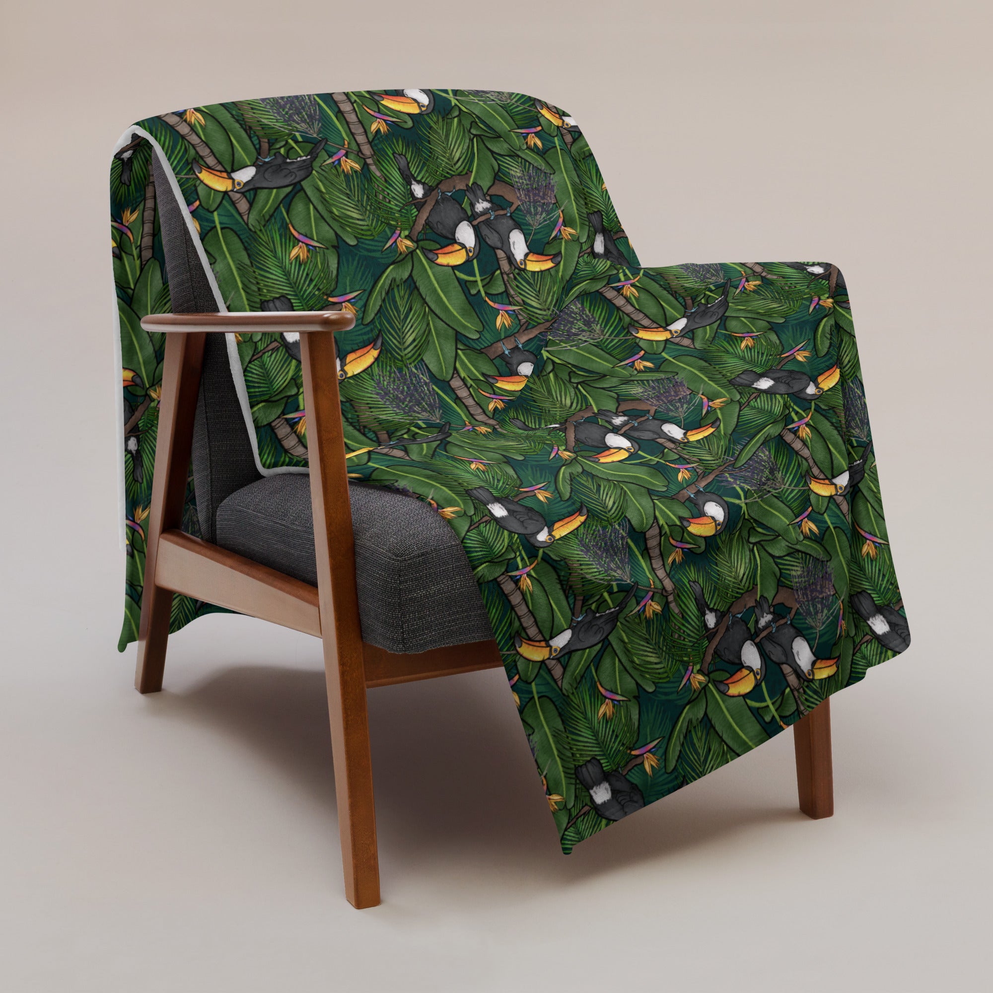 image of 60" x 80" Toucans in the jungle pattern blanket draped over a chair